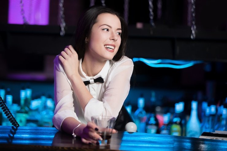 Live dealer at roulette table in professional casino studio alongside PUBG Mobile tournament commentary overlay